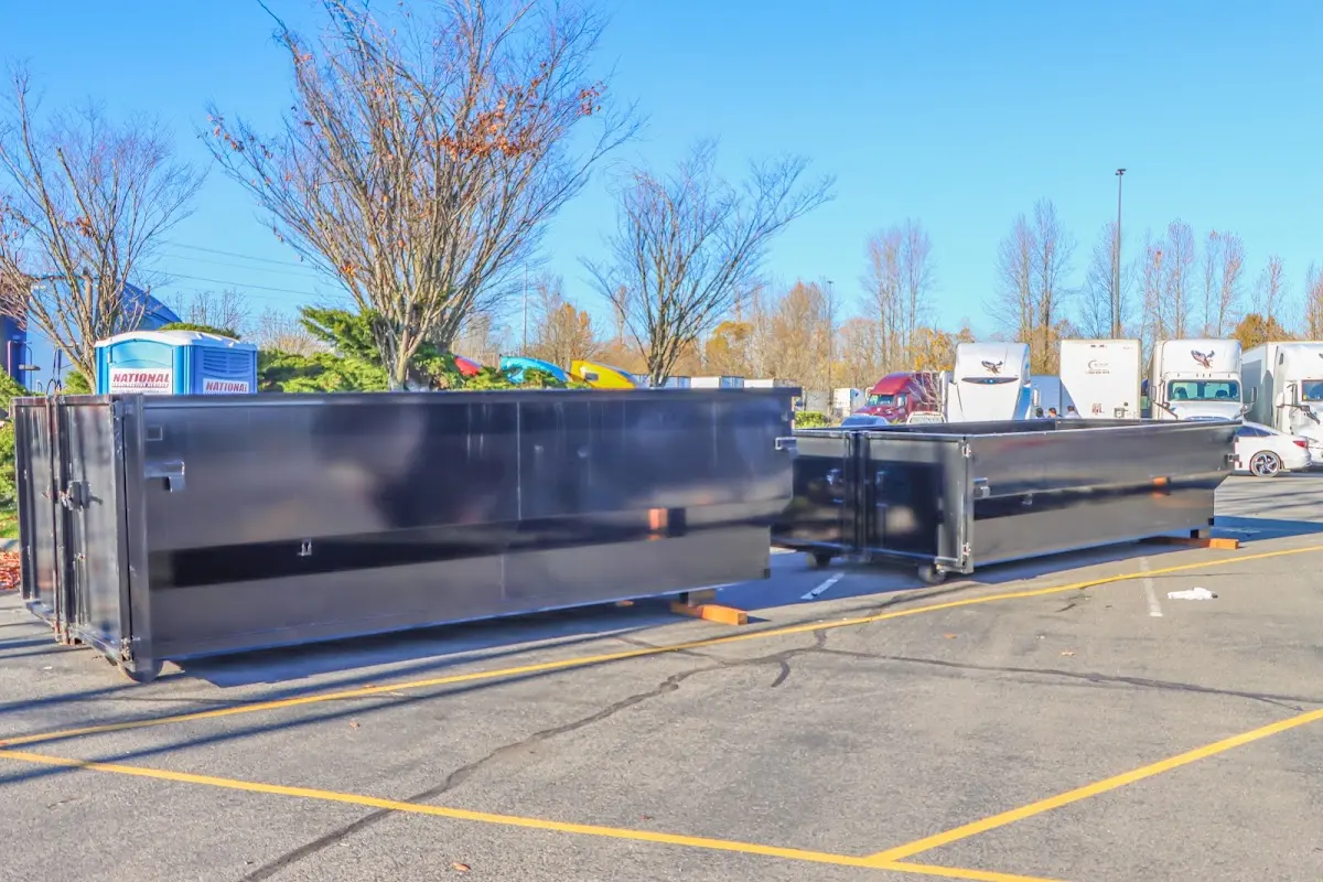 Professional dumpster rental service with roll-off container on residential driveway in Rome